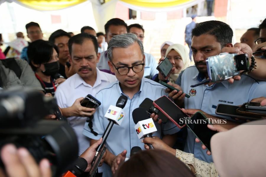 Communications Minister Fahmi Fadzil speaks to reporters in Seberang Perai. -NSTP/MIKAIL ONG