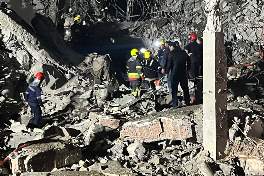 This handout photograph released and taken on January 16, 2024 by Kurdistan 24 broadcast news station shows firemen and security staff inspecting the rubble of a building at a site hit by a missile attack launched by Iran's Islamic Revolutionary Guard Corps (IRGC), in Arbil, the capital of Iraq's northern autonomous Kurdish region. -AFP PIC