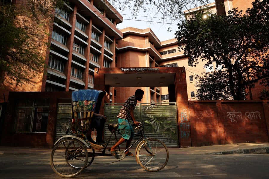A rickshaw passes by a school named Udayan Uchcha Madhyamik Bidyalaya as all schools are closed due to on going heatwave in Dhaka, Bangladesh. - REUTERS PIC