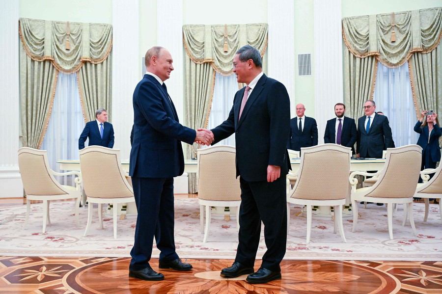 Russia's President Vladimir Putin (L) meets Premier of the State Council of China Li Qiang in Moscow.- AFP PIC