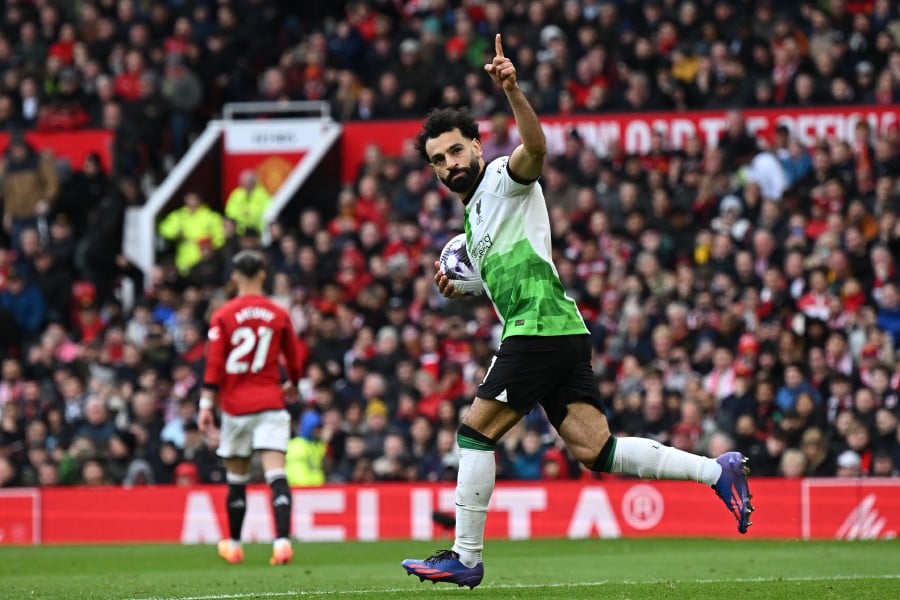 Liverpool's Mohamed Salah celebrates after scoring their second goal from the penalty spot against Manchester United at Old Trafford in Manchester. - AFP PIC