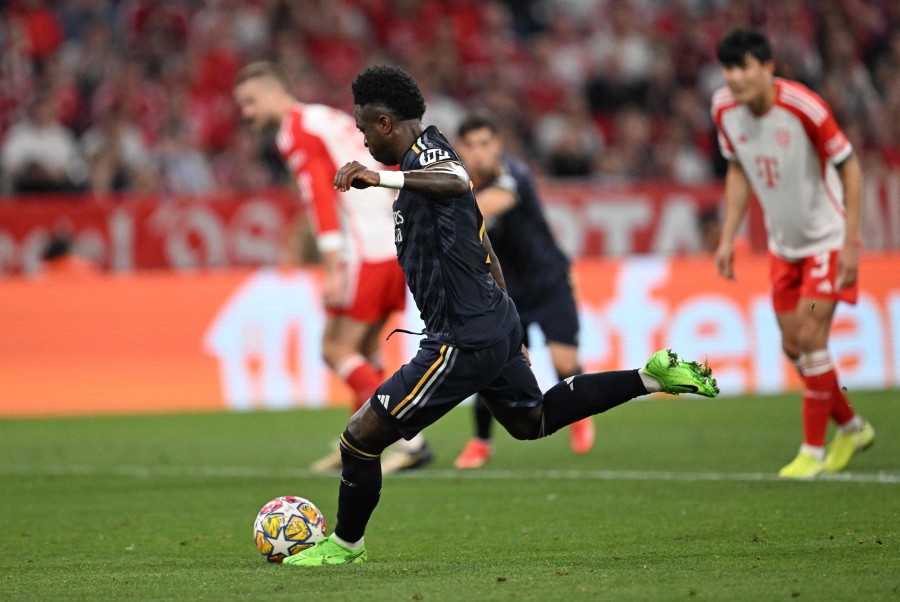 Real Madrid's Vinicius Junior scores a penalty during the UEFA Champions League semi-final first leg football match against Bayern Munich in Munich. - AFP PIC
