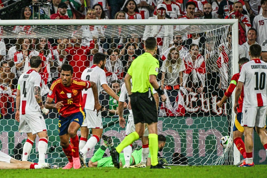 Spain's midfielder Rodri celebrates scoring his team's first goal past Georgia's goalkeeper Giorgi Mamardashvili during the UEFA Euro 2024 round of 16 football match between Spain and Georgia at the Cologne Stadium in Cologne. - AFP PIC