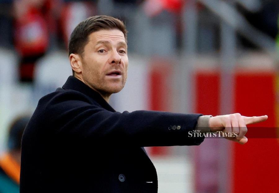 Leverkusen coach Xabi Alonso said that they will be swamped facing three finals this week. - REUTERS PIC