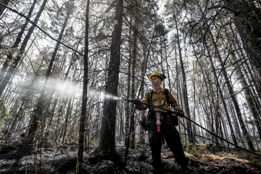 Firefighter Kalen MacMullin of Sydney, Nova Scotia, Canada works at the Barrington Wildfire Complex in the province, in this social media handout image released June 1, 2023. -- Pic: NOVA SCOTIA GOVERNMENT/Handout via REUTERS 