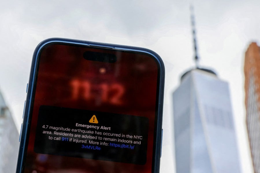 A photo illustration shows an emergency alert of a magnitude 4.7 earthquake on a cellphone in New York City, U.S., April 5, 2024. -- REUTERS