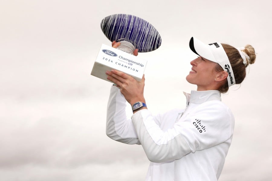 Nelly Korda of the United States poses with the trophy after the final round of the Ford Championship presented by KCC at Seville Golf and Country Club on March 31, 2024 in Phoenix, Arizona. -AFP/Christian Petersen