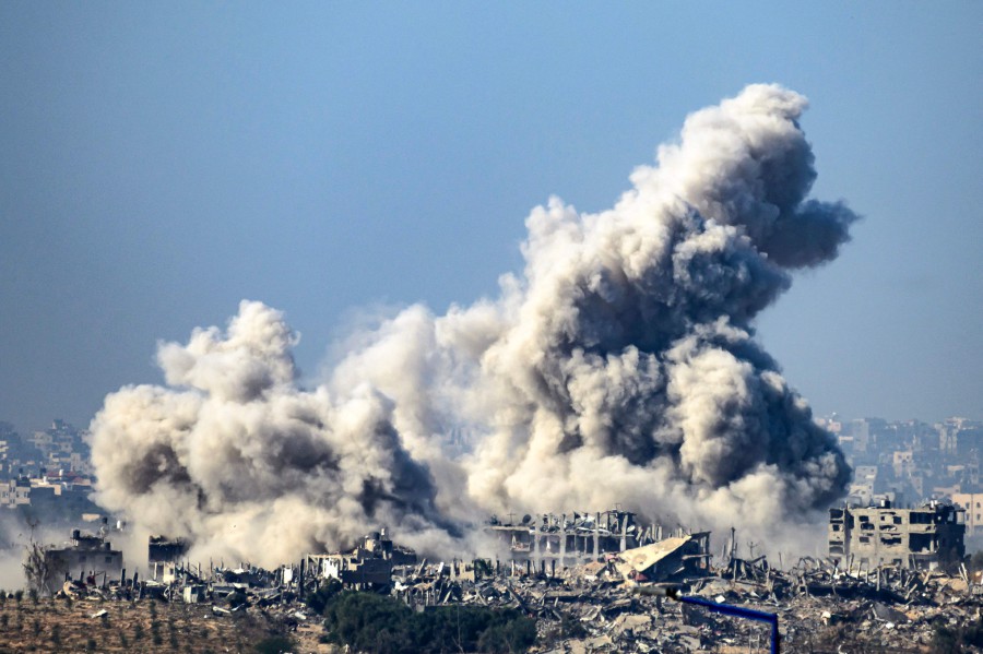 This picture taken from southern Israel near the border with the Gaza Strip shows smoke rising from buildings after being hit by Israeli strikes, as battles resume between Israel and Hamas. -AFP/John MACDOUGALL