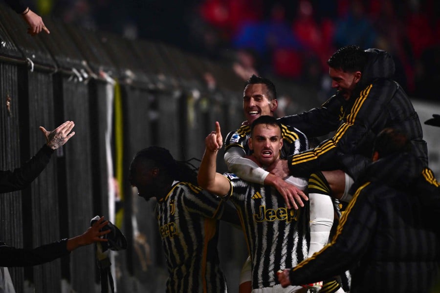 Juventus' Italian defender #04 Federico Gatti celebrates with teammates after scoring the team's second goal during the Italian Serie A football match between AC Monza and Juventus at the Bianteo stadium in Monza. -AFP/Marco BERTORELLO