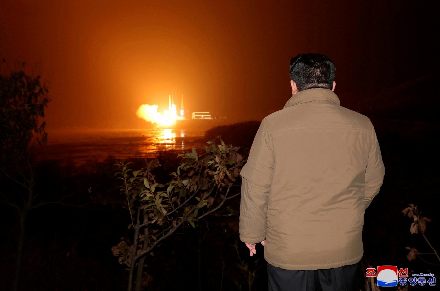 (FILE PHOTO) North Korean leader Kim Jong Un looks on as a rocket carrying a spy satellite Malligyong-1 is launched, as North Korean government claims, in a location given as North Gyeongsang Province, North Korea in this handout picture. -REUTERS PIC