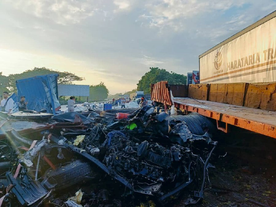 The drivers of two of the lorries, one laden with metal structures and the other, with sugar, were pinned in their seats and died at the scene. -PIC COURTESY OF FIRE AND RESCUE DEPARTMENT