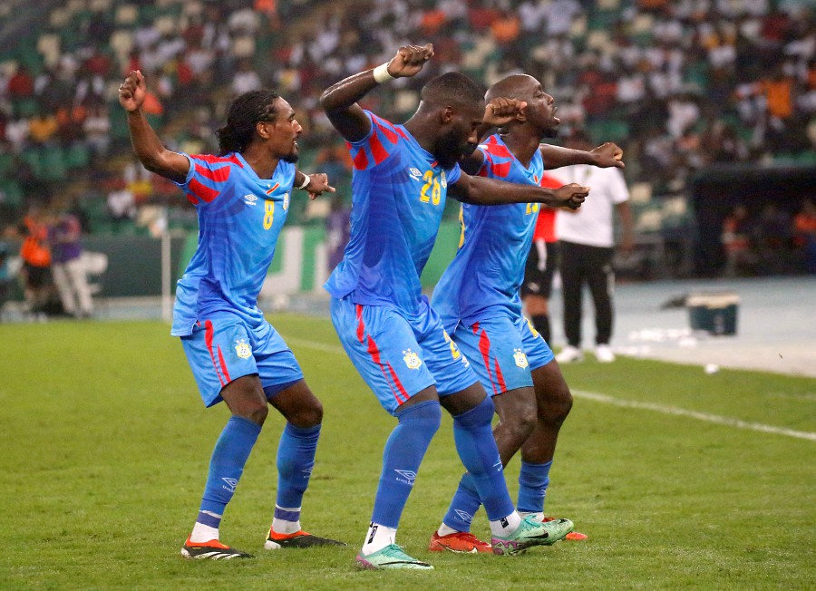 DR Congo's Yoane Wissa celebrates scoring their second goal with Arthur Masuaku and Samuel Moutoussamy. -REUTERS/Luc Gnago