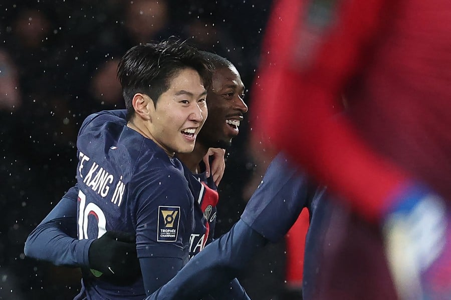 Paris Saint-Germain's South Korean midfielder #19 Lee Kang-in (left) celebrates with Paris Saint-Germain's French forward #10 Ousmane Dembele after scoring the opening goal the French Champions' Trophy (Trophee des Champions) football match between Paris Saint-Germain (PSG) and Toulouse FC at the Parc des Princes stadium in Paris on January 3, 2024. -AFP/FRANCK FIFE