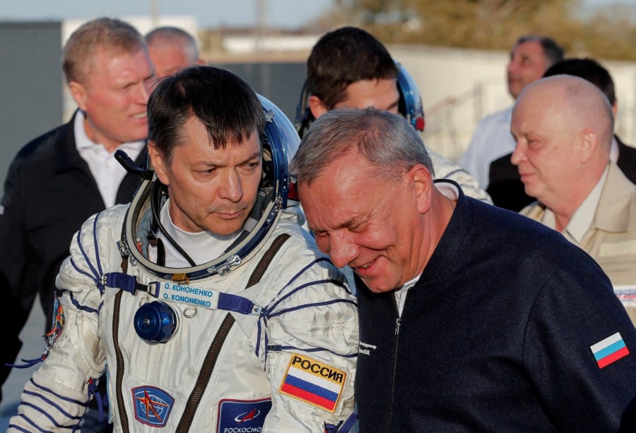 (FILE PHOTO) Chief of Russian space agency Roscosmos Yuri Borisov accompanies cosmonaut Oleg Kononenko, who boards the Soyuz MS-24 spacecraft at the Baikonur cosmodrome, Kazakhstan, September 15, 2023. -REUTERS/Maxim Shipenkov