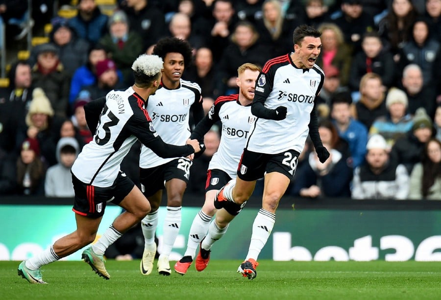 Fulham's Joao Palhinha celebrates scoring their first goal with teammates. -REUTERS/Peter Powell