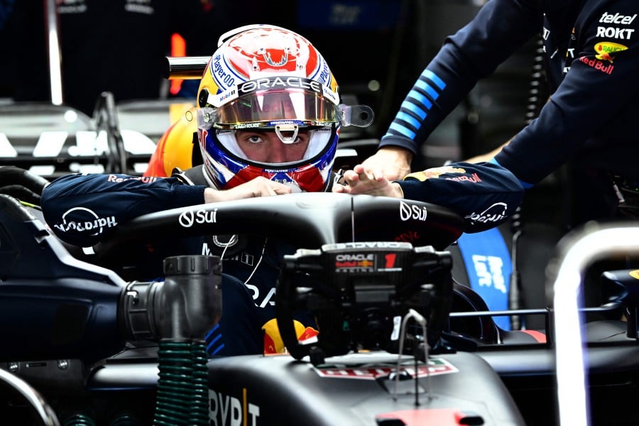 Red Bull Racing's Dutch driver Max Verstappen gets into his car before the start of the first practice session ahead of the Formula One Japanese Grand Prix race at the Suzuka circuit in Suzuka, Mie prefecture on April 5, 2024. -AFP/Yuichi YAMAZAKI