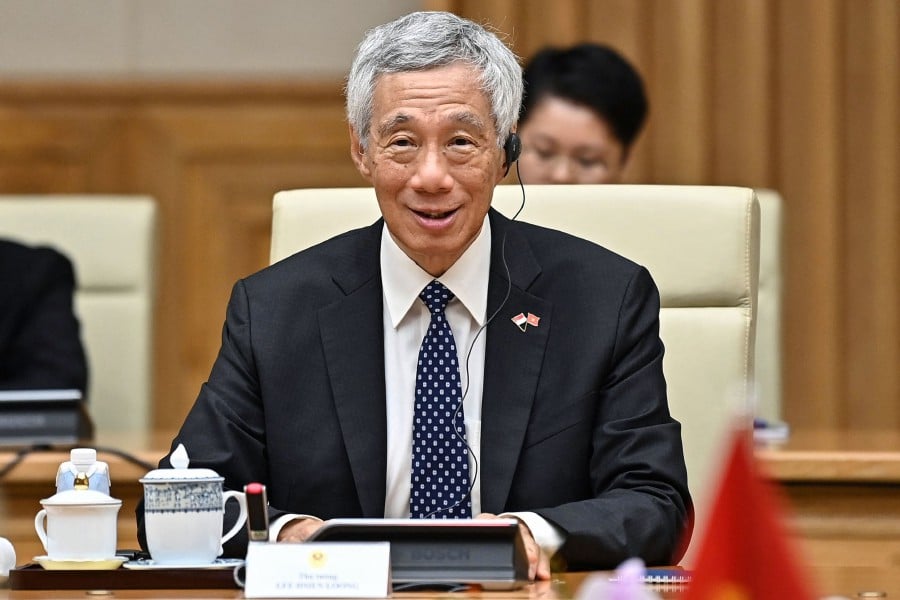 (FILE PHOTO) Singapore's Prime Minister Lee Hsien Loong attends a bilateral meeting with Vietnam's Prime Minister Pham Minh Chinh at the Government Office in Hanoi. Singapore Prime Minister Lee Hsien Loong, who has been in office since 2004, announced on November 5, 2023 he will hand over power to the current finance minister Lawrence Wong, 50, before the 2025 general elections. -AFP/Nhac NGUYEN