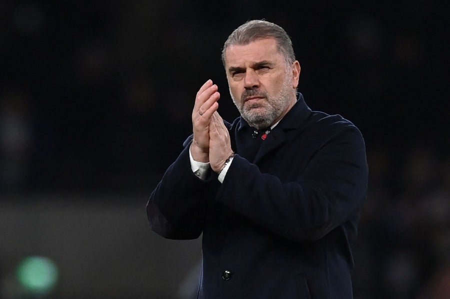 Tottenham Hotspur's Greek-Australian Head Coach Ange Postecoglou applauds fans on the pitch after the English FA Cup third round football match between Tottenham Hotspur and Burnley at Tottenham Hotspur Stadium in London. -AFP/Glyn KIRK