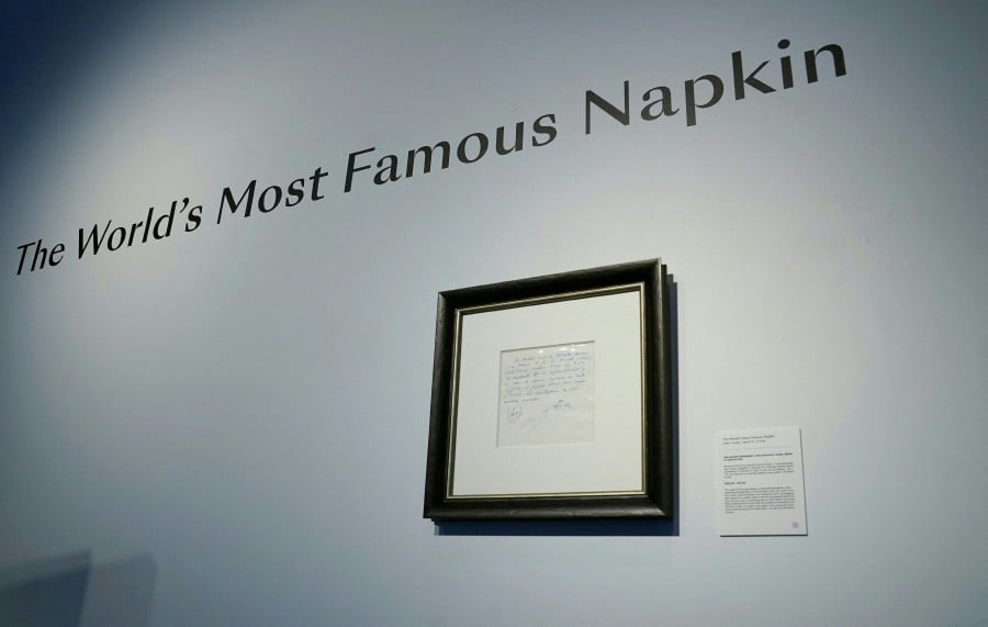 A napkin on which was written the first promise of a contract to secure 13-year-old Lionel Messi for FC Barcelona, is on display at Bonhams, New York. The napkin written by Barcelona's Sporting Director Carles Rexach on December 14, 2000, will be sold during an online auction by the Bonhams auction house from March 18-27. -AFP/TIMOTHY A. CLARY