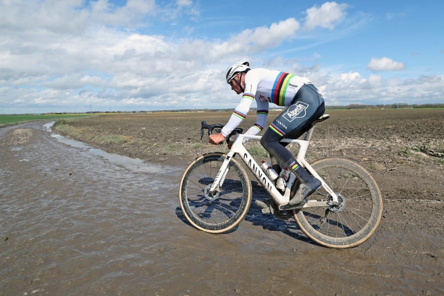 Mathieu van der Poel (Alpecin-Deceuninck) rides on the paved sector during a reconnaissance ride for the 121st edition of the Paris-Roubaix upcoming cycling event near Haveluy on April 5, 2024. -AFP/Francois LO PRESTI
