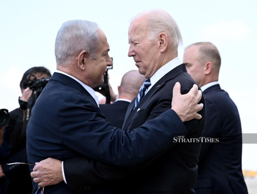 (FILE PHOTO) Israel Prime Minister Benjamin Netanyahu (left) greets US President Joe Biden upon his arrival at Tel Aviv's Ben Gurion airport on October 18, 2023. Biden spoke by phone with Netanyahu April 4, 2024, the White House said, amid growing outrage over an Israeli strike that killed seven aid workers in Gaza. -AFP/Brendan SMIALOWSKI