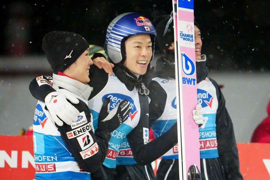 Japan's Ryoyu Kobayashi (centre) reacts after the second jump of the fourth stage of the Four-Hills tournament (Vierschanzentournee) as part of the FIS Ski Jumping World Cup, in Bischofshofen, Austria. -AFP/GEORG HOCHMUTH/APA