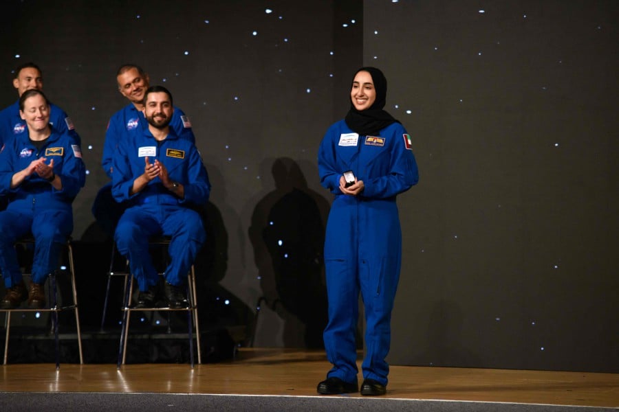 Nora AlMatrooshi, a NASA Artemis astronaut candidate graduate, smiles during a ceremony at Johnson Space Center in Houston, Texas. -AFP/Mark Felix