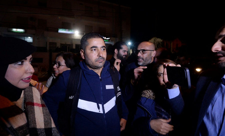 Tunisian journalist Khalifa Guesmi (centre) speaks with journalists after his release in front of the Tebourba prefecture. Tunisia's Court of Cassation on March 6 overturned the journalist's prison sentence for revealing information about the security services, his lawyer said, paving the way for a retrial. Khalifa Guesmi, a correspondent for Tunisia's most popular radio station Mosaique FM, was convicted in November and handed a one-year prison sentence that was later increased to five years on appeal. -AFP/SOFIENE HAMDAOUI