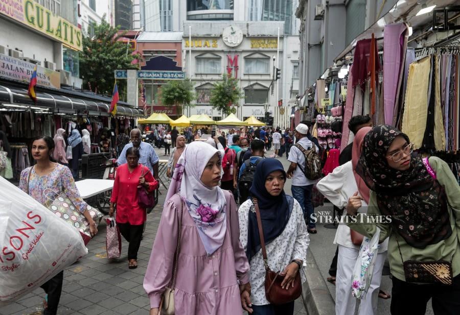 Jalan Tunku Abdul Rahman steadily gaining foot traffic since 9am while many shops had pulled an all-nighter to ensure sales targets were met. -NSTP/HAZREEN MOHAMAD