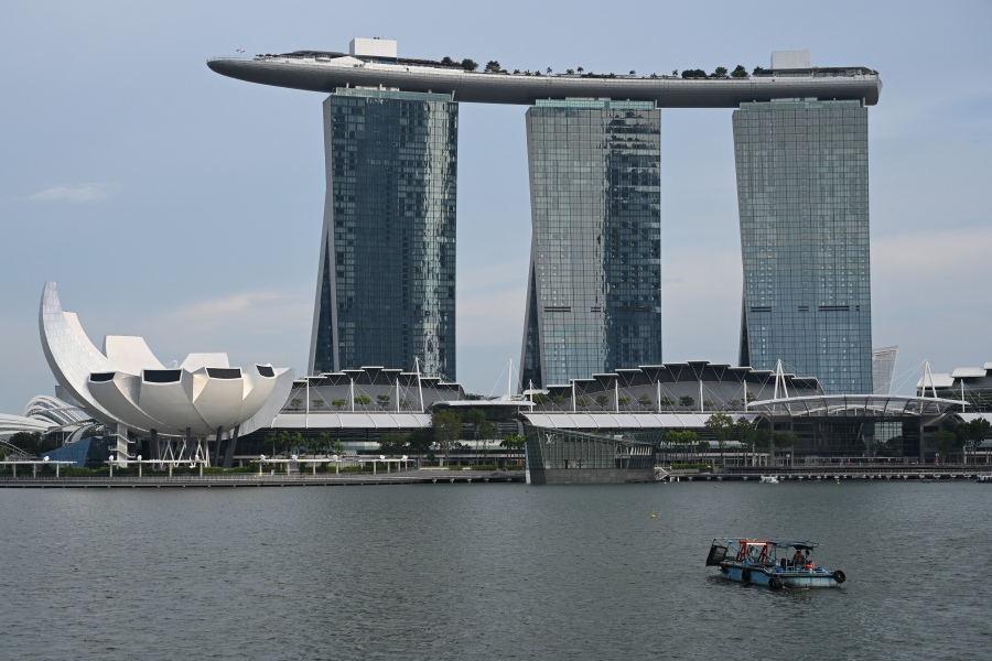 The ArtScience Museum (left) and Marina Bay Sands hotel and resort are seen in Singapore. (Photo by Roslan RAHMAN / AFP)