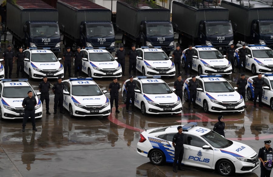 (FILE PHOTO) Policemen standing in front of a new patrol car (MPV). -BERNAMA PIC