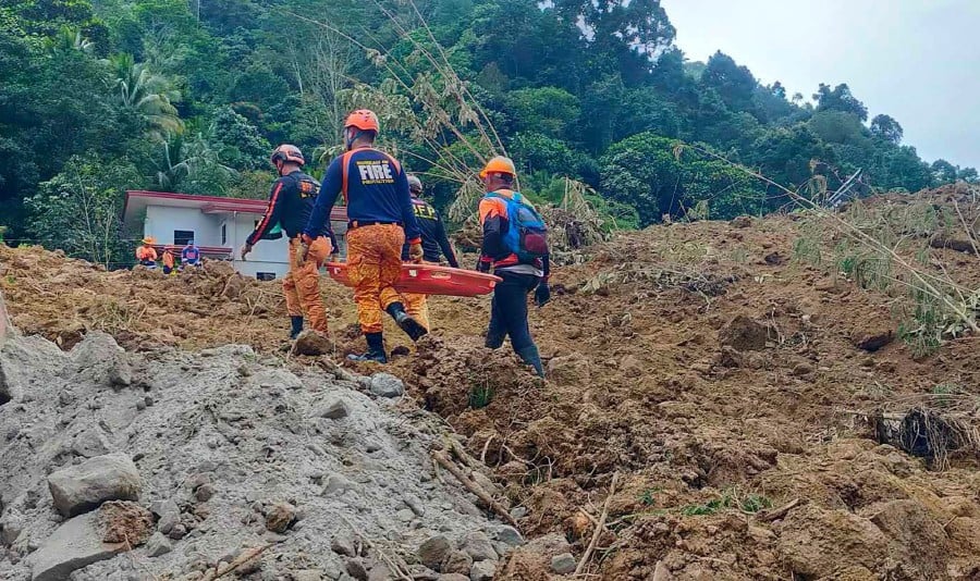 This handout photo taken on February 7, 2024 and obtained from the Facebook page of the Office of the Provincial Fire Marshal (OPFM) Davao de Oro shows responders conduct rescue operations at the site of a landslide in Maco, Davao de Oro. -AFP/HO/OPFM DAVAO DE ORO