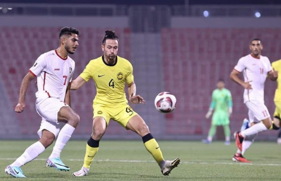 Malaysia (in yellow) and Syria in action in Monday's closed-door friendly in Doha. -PIC COURTESY OF FAM