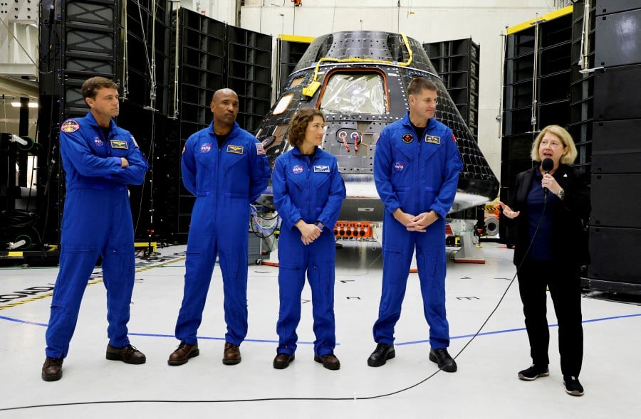 (FILE PHOTO) Astronauts for NASA's Artemis II mission stand in front of their Orion crew capsule, expected to carry Reid Wiseman, commander, Victor Glover, pilot, and mission specialists Christina Hammock Koch and Jeremy Hansen, with the Canadian Space Agency, as NASA Deputy Administrator Pam Melroy speaks at a press conference at the Kennedy Space Center in Cape Canaveral, Florida, US, August 8, 2023. -REUTERS/Joe Skipper