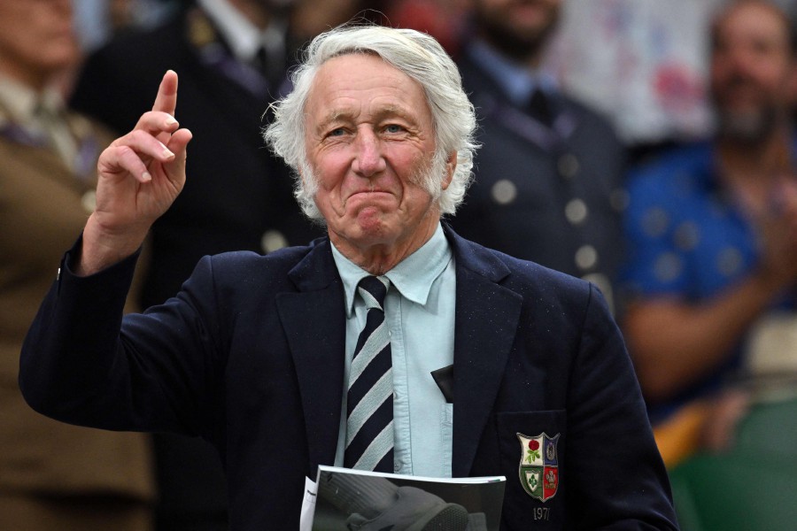 (FILE PHOTO) Former Welsh rugby union player John Peter Rhys JPR Williams gestures at the Centre Court's Royal Box, on the sixth day of the 2023 Wimbledon Championships at The All England Tennis Club in Wimbledon, southwest London, on July 8, 2023. Former Wales and British Lions full-back JPR Williams has died at the age of 74, his former club Bridgend announced January 8. -AFP/Glyn KIRK