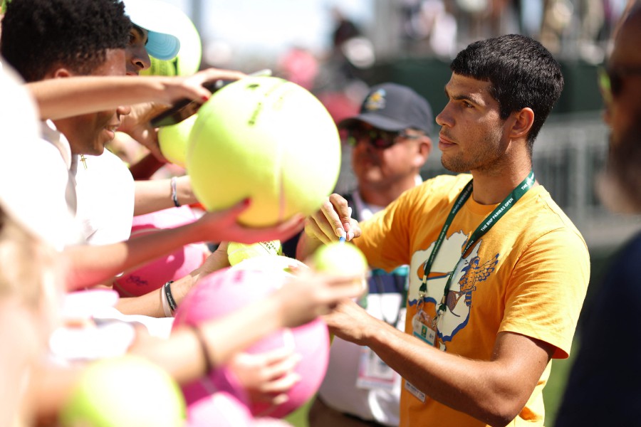 ICarlos Alcaraz of Spain signs autographs for fans after a training session during the BNP Paribas Open at Indian Wells Tennis Garden in Indian Wells, California. -AFP/CLIVE BRUNSKILL