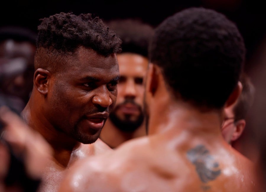 Francis Ngannou with Anthony Joshua after losing the fight. -REUTERS/Andrew Couldridge