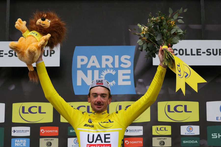 UAE Team Emirates' US cyclist Brandon Mcnulty celebrates his overall leader yellow jersey on the podium during the 6th stage of the Paris-Nice cycling race, 198,5 km between Sisteron and La Colle-sur-Loup. -AFP/Thomas SAMSON