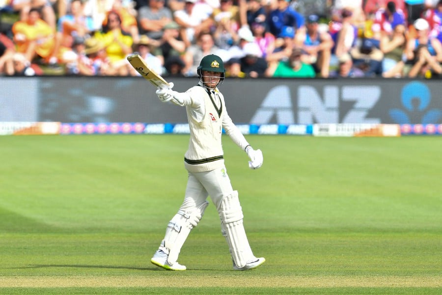 Australia's Marnus Labuschagne raises his bat after scoring a half century (50 runs) on day two of the second Test cricket match between New Zealand and Australia at Hagley Oval in Christchurch. -AFP/Sanka Vidanagama