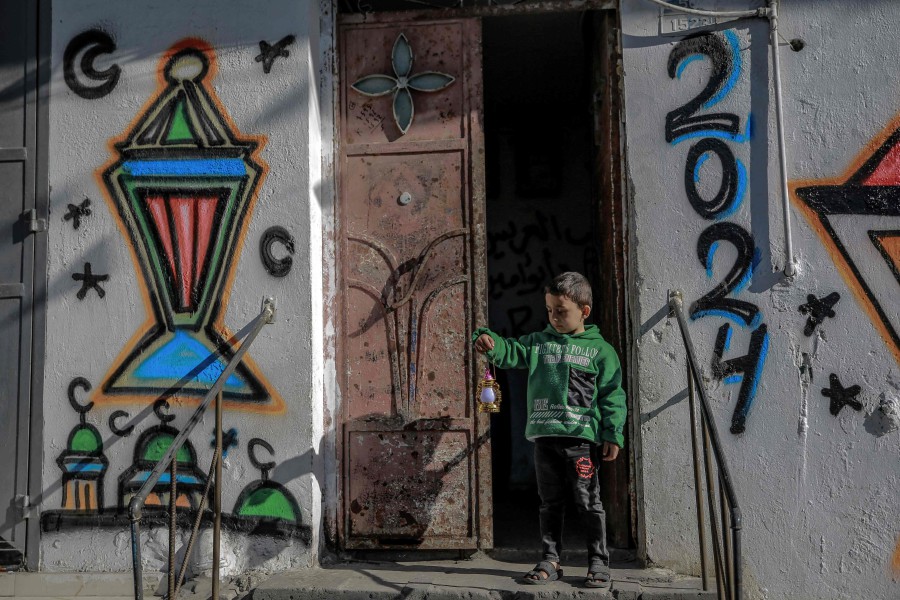 A child carries a small Ramadan lantern in Gaza City on March 8, 2024, as Muslim worshippers prepare to welcome the holy fasting month of Ramadan which begins next week. -AFP PIC