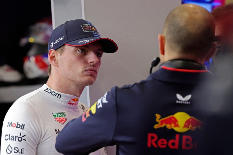 Red Bull Racing's Dutch driver Max Verstappen talks to members of his team in the garage ahead of the qualifying session of the Saudi Arabian Formula One Grand Prix at the Jeddah Corniche Circuit in Jeddah. -AFP/Giuseppe CACACE