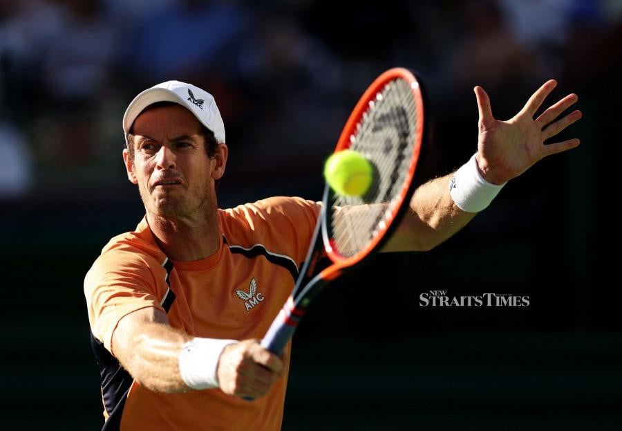 Andy Murray of Great Britain plays a backhand against against Andrey Rublev in their second round match during the BNP Paribas Open at Indian Wells Tennis Garden in Indian Wells, California. -AFP/CLIVE BRUNSKILL