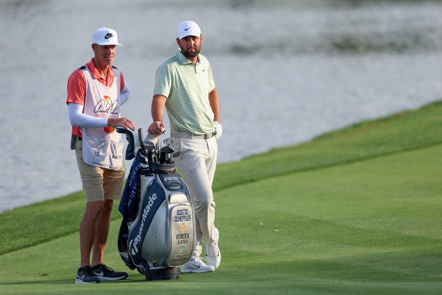 Scottie Scheffler of the United States and his caddie Ted Scott (left) talk while playing the 18th hole during the third round of the Arnold Palmer Invitational presented by Mastercard at Arnold Palmer Bay Hill Golf Course in Orlando, Florida. -AFP/Brennan Asplen