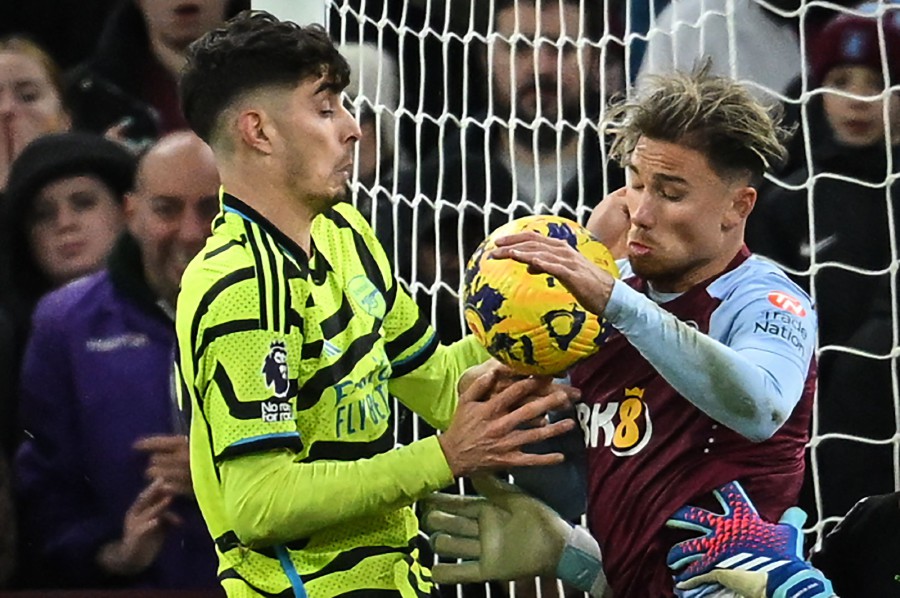 Arsenal's German midfielder #29 Kai Havertz (left) and Aston Villa's English defender #02 Matty Cash (right) fight for the ball in front of the goal during the English Premier League football match between Aston Villa and Arsenal at Villa Park in Birmingham, central England on December 9, 2023. -AFP/JUSTIN TALLIS