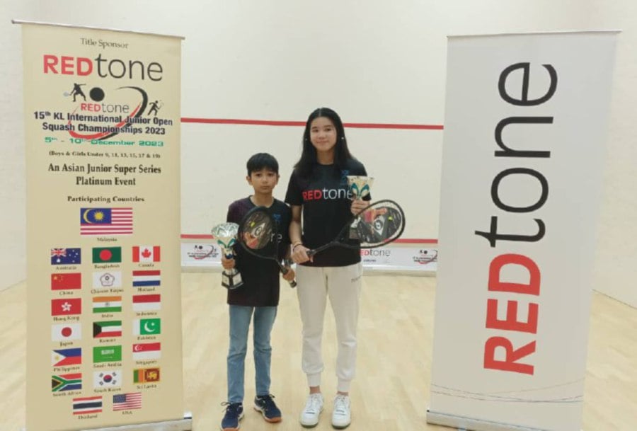 Harleein (right) and Hisshan Nair with their REDtone Kuala Lumpur International Junior Championships trophies in Kuala Lumpur.