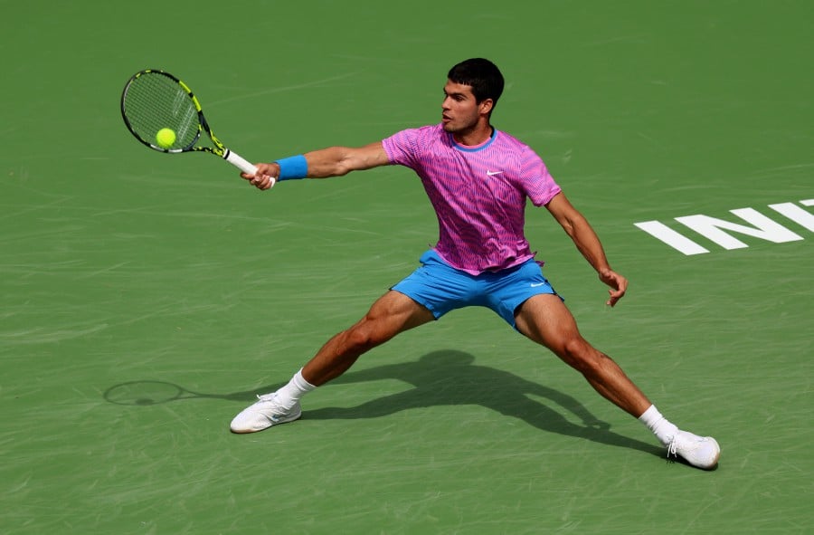 Carlos Alcaraz of Spain plays a forehand against Felix Auger-Aliassime of Canada in their third round match during the BNP Paribas Open at Indian Wells Tennis Garden in Indian Wells, California. -AFP/CLIVE BRUNSKILL