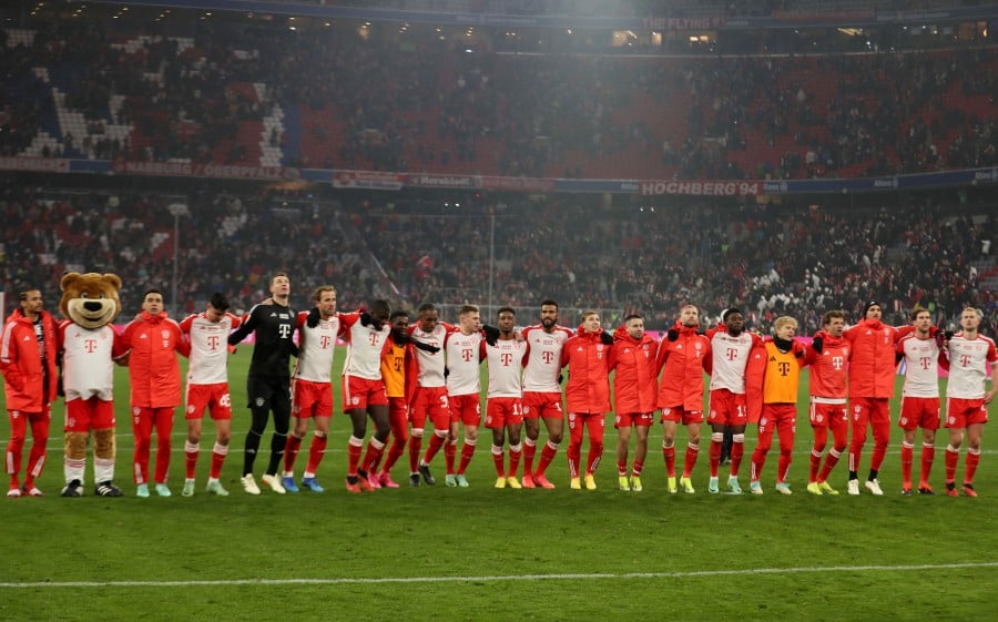 Bayern Munich players and mascot Berni celebrate after the match. -REUTERS/Leonhard Simon