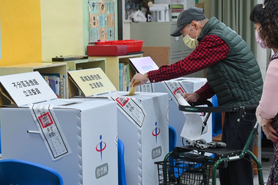 A man casts his vote in the presidential election at a polling station inside an elementary school in New Taipei City on January 13, 2024. -AFP/Sam Yeh