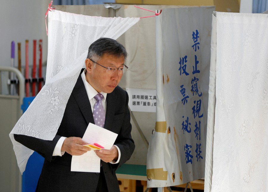 Ko Wen-je, presidential candidate of Taiwan People's Party (TPP), walks out from a voting booth before casting his ballot during the presidential and parliamentary elections in Taipei, Taiwan January 13, 2024. -REUTERS/Carlos Garcia Rawlins