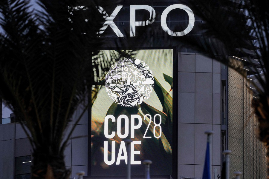 The logo of the United Nations Climate Change Conference COP28 is pictured at Expo City in Dubai on December 12, 2023. (Photo by Giuseppe CACACE / AFP)